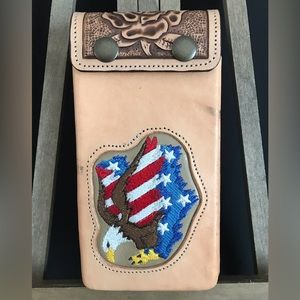 Handmade all leather cell phone carrier with clip on back to put on belt.